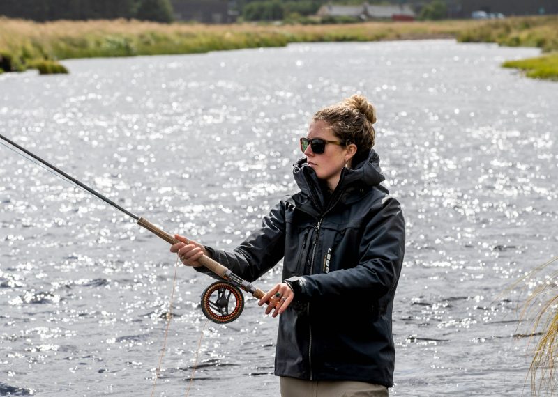 Female angler fly fishing for Rainbow Trout in Scotland